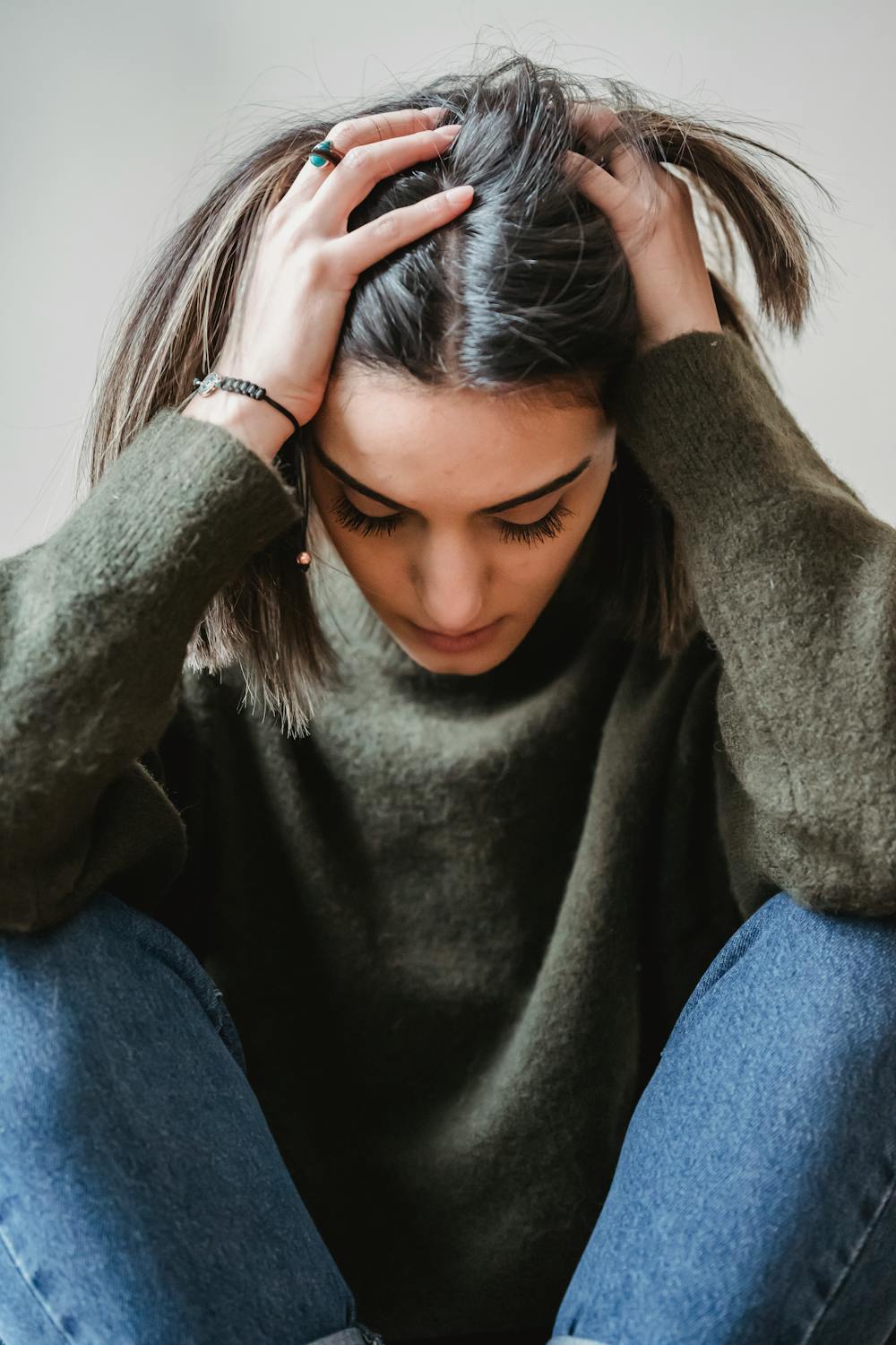 girl holding her head 